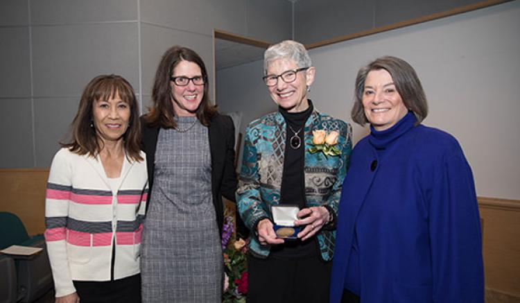 Margaret Wallhagen receives the Helen Nahm Lecture Award. Pictured (from left to right) are faculty members Melinda Bender, Heather Leutwyler, Wallhagen and Dean Catherine L. Gilliss.