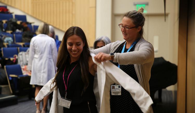 The White Coat Ceremony is a rite of passage for new students. (Photo credit: Mark Wooding)