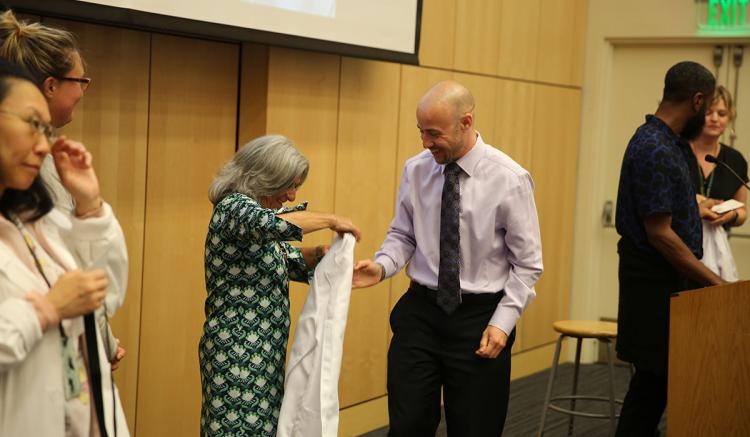 The White Coat Ceremony welcomes students to the health care profession. (Photo credit: Mark Wooding)