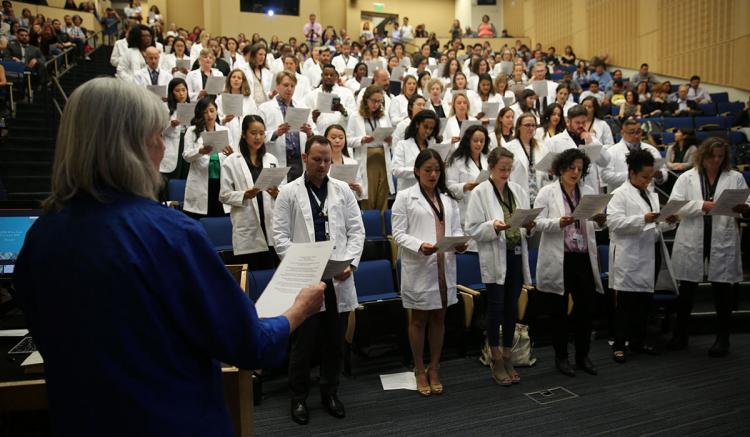 Faculty member Sheila Proctor leads the students in the recitation of the International Council of Nursing code of ethnics.