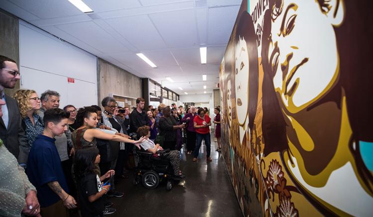Faculty, students, staff, alumni and special guests celebrate the unveiling of the new mural. (Photography by Elisabeth Fall)
