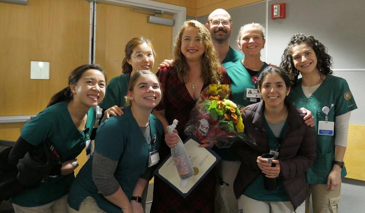 DNP graduate Angelita Barrios, who also teaches MEPN courses at the School, is surrounded by MEPN students who came to celebrate her achievement. 