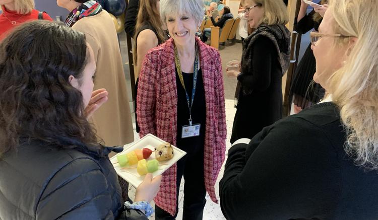 Faculty member Deborah Johnson speaks with graduates and their families at the reception at the DNP program's closing ceremony.