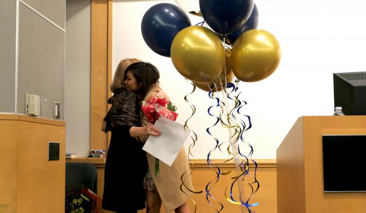 DNP graduate Cheryl Catalan hugs faculty member Marianne Hultgren at the DNP closing ceremony.