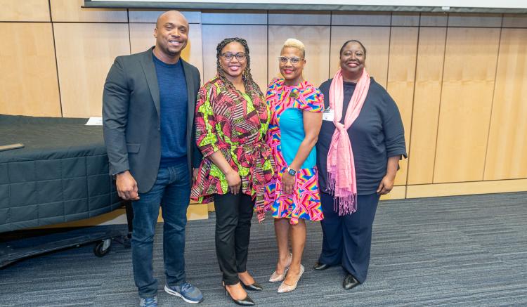 Assistant Professor Orlando Harris (left) and Associate Dean Catherine Waters (right) are pictured with conference coordinators. 