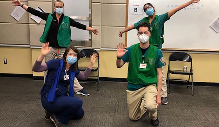 Nursing students Casady Brown, Gal Haroush and Scott Berning, with assistant professor Kate Holbrook at the UCSF vaccine clinic where they are volunteering.
