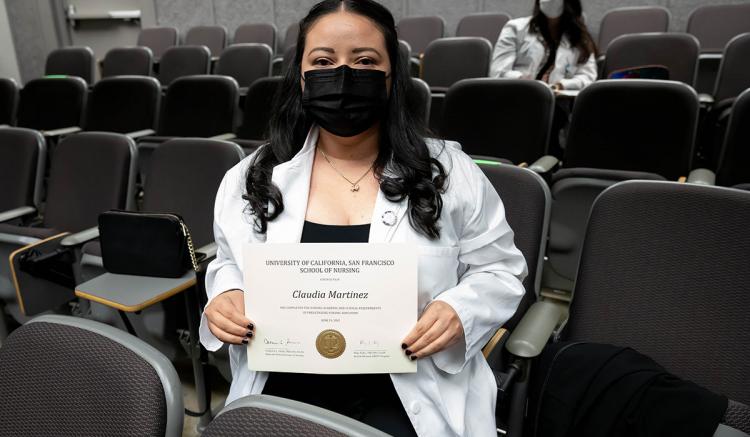 Student Claudia Martinez holds her certificate during the MEPN Pinning Celebration. 