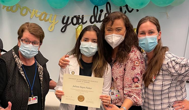 Student Julissa Haya (center) receives a hug from faculty member Angelita Barrios as she receives her certificate. Also pictured are MEPN Interim Director Mary Foley (far left) and Clinical Nurse Educator Erin Levardo (at right).