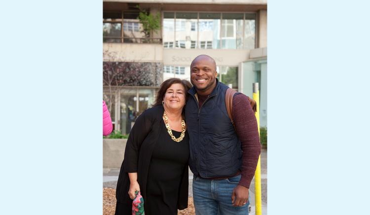 Orlando Harris, assistant professor, congratulates Carol Dawson-Rose on her Helen Nahm Research Lecture Award.