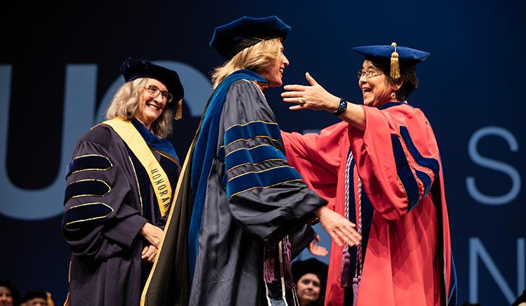 Sandra Domeracki embraces adviser Oi Saeng Hong at the 2026 UCSF School of Nursing Commencement at the Palace of Fine Arts. 