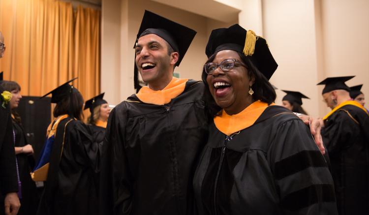 students and speakers await graduation