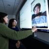 Student and instructor looking at an image on a screen