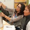 Two workshop participants check an oxygen tank's level.