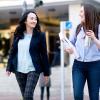 Cherry Leung smiling and walking with a student. 