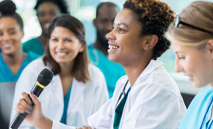 Healthcare worker holding microphone