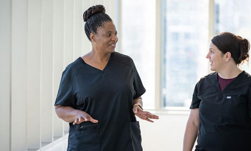 PMHNP student Janet Meda, left, speaks with her preceptor Ann Marie Coria, who is a PMHNP at UC Davis Health. The UCSF, UC Davis and UCLA schools of nursing have partnered to prepare 300 PMHNPs within a five-year period.