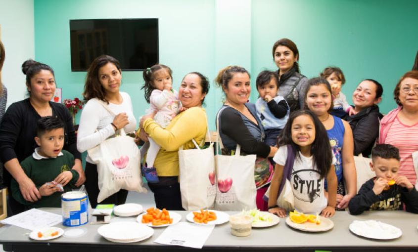 Nadia Al-Lami (left) and Victoria Keeton (right) with Head Start families after a nutrition class  (photos by Elisabeth Fall)