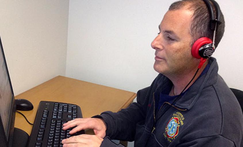 A firefighter participates in internet-based, hearing-loss training.