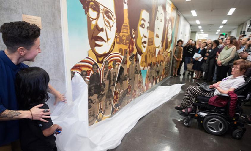 Faculty, students, staff, alumni and special guests celebrate the unveiling of the new mural at the UCSF School of Nursing (Photography by Elisabeth Fall)