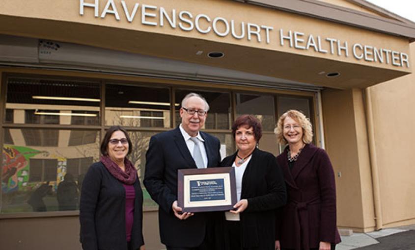 At Havenscourt Health Center, partners in Elev8 from UC San Francisco School of Nursing and the Alameda County Center for Healthy Schools and Communities celebrate recognition from the American Association of Colleges of Nursing. From left are: Naomi Schapiro, director of the Elev8 program for the School; Dean David Vlahov; Tracy Schear, director of the Center for Healthy Schools and Communities and Linda Franck, chair of the School's Department of Family Health Care Nursing.