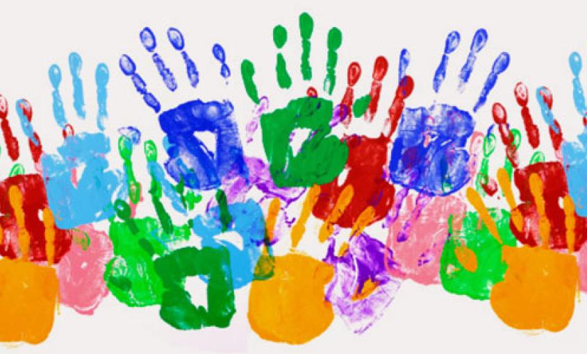 Picture of overlapping handprints made in colorful paint. 
