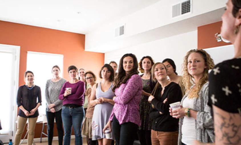 Nicole Sata (second from left) and Darcy Stanley (fourth from left) open a training session for prospective doulas (photos by Elisabeth Fall).