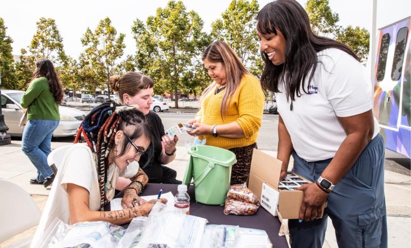Natalie Wilson and members of the HOPE mobile clinic team hand out hygiene kits in Oakland.