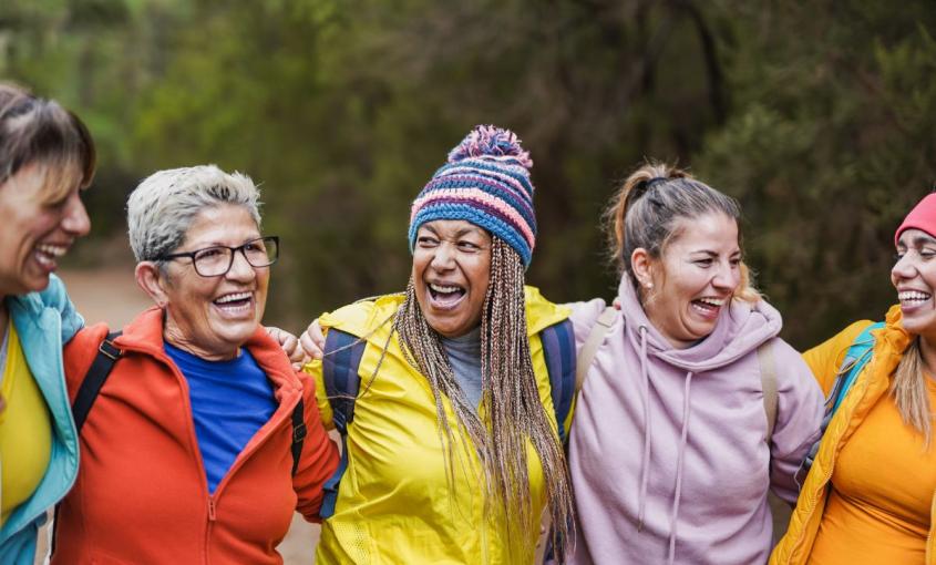 Five women stand together