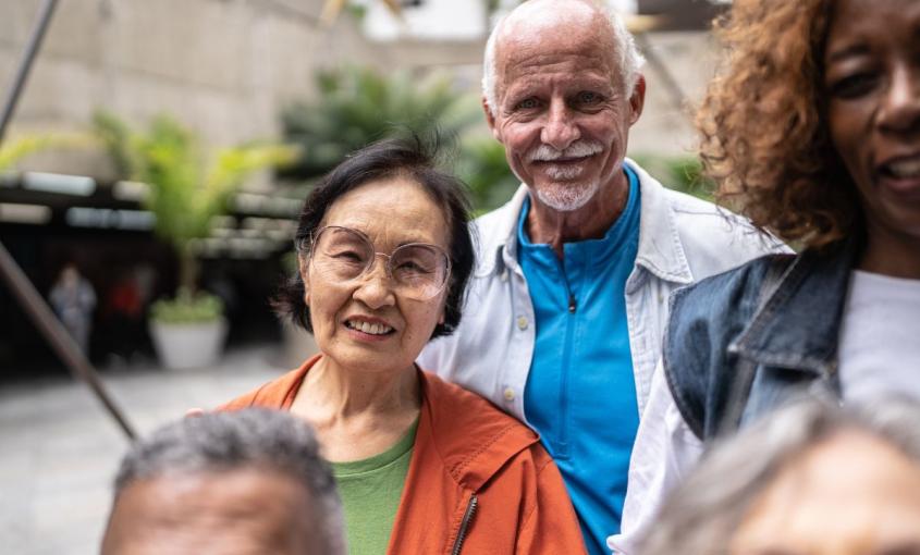 Five adults standing outside