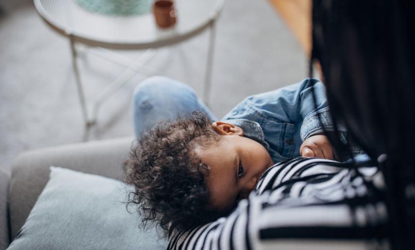 Adult breastfeeding an infant