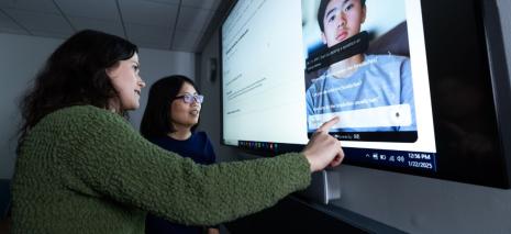 Student and instructor looking at an image on a screen