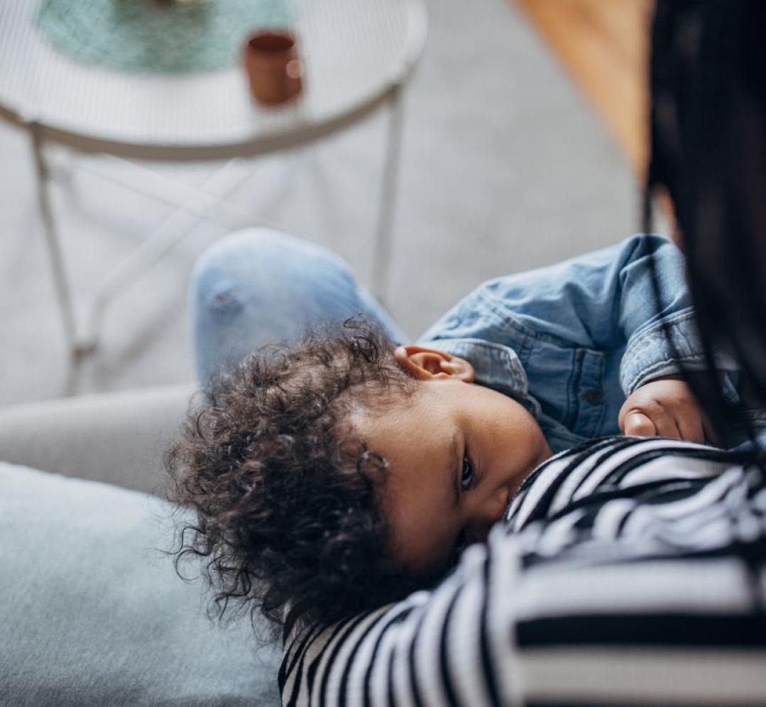Adult breastfeeding an infant