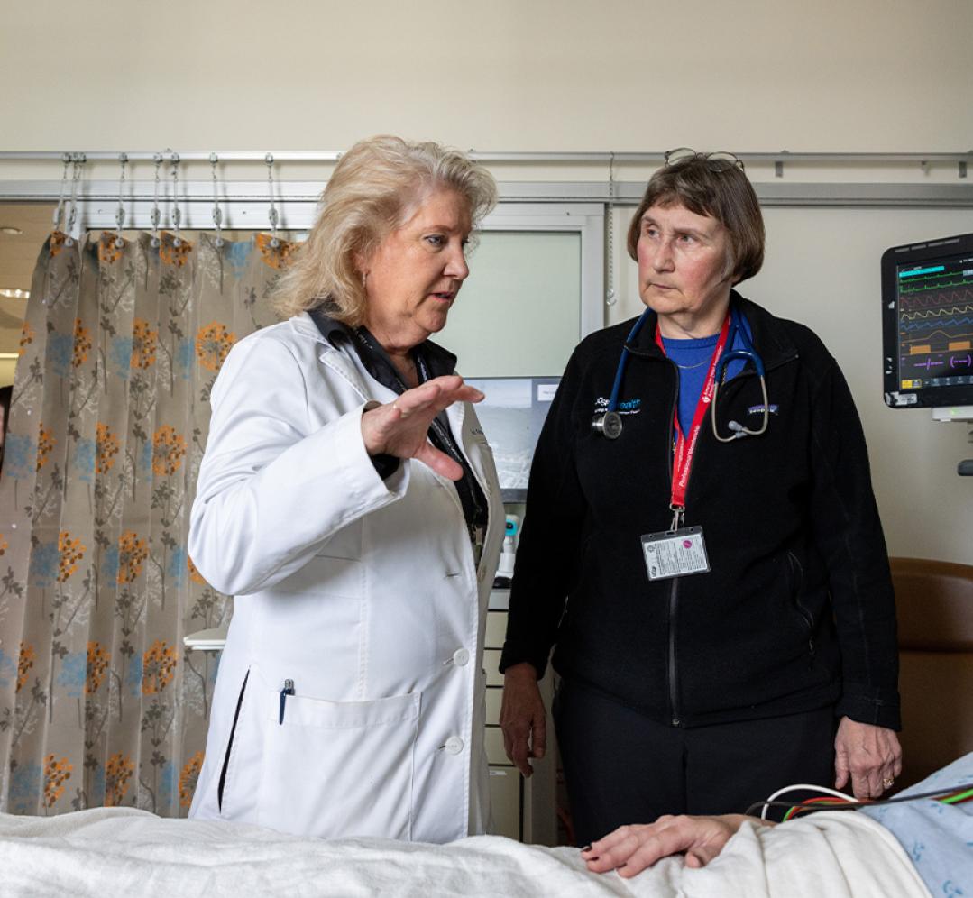 Michele Pelter, PhD, RN, speaks to Kirsten Fleischmann, MD, MPH, and a patient from a hospital room in the cardiac ICU. 